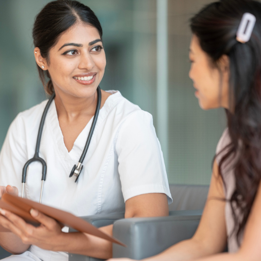 Healthcare professional having a friendly discussion with a patient, emphasizing trust, care, and support.