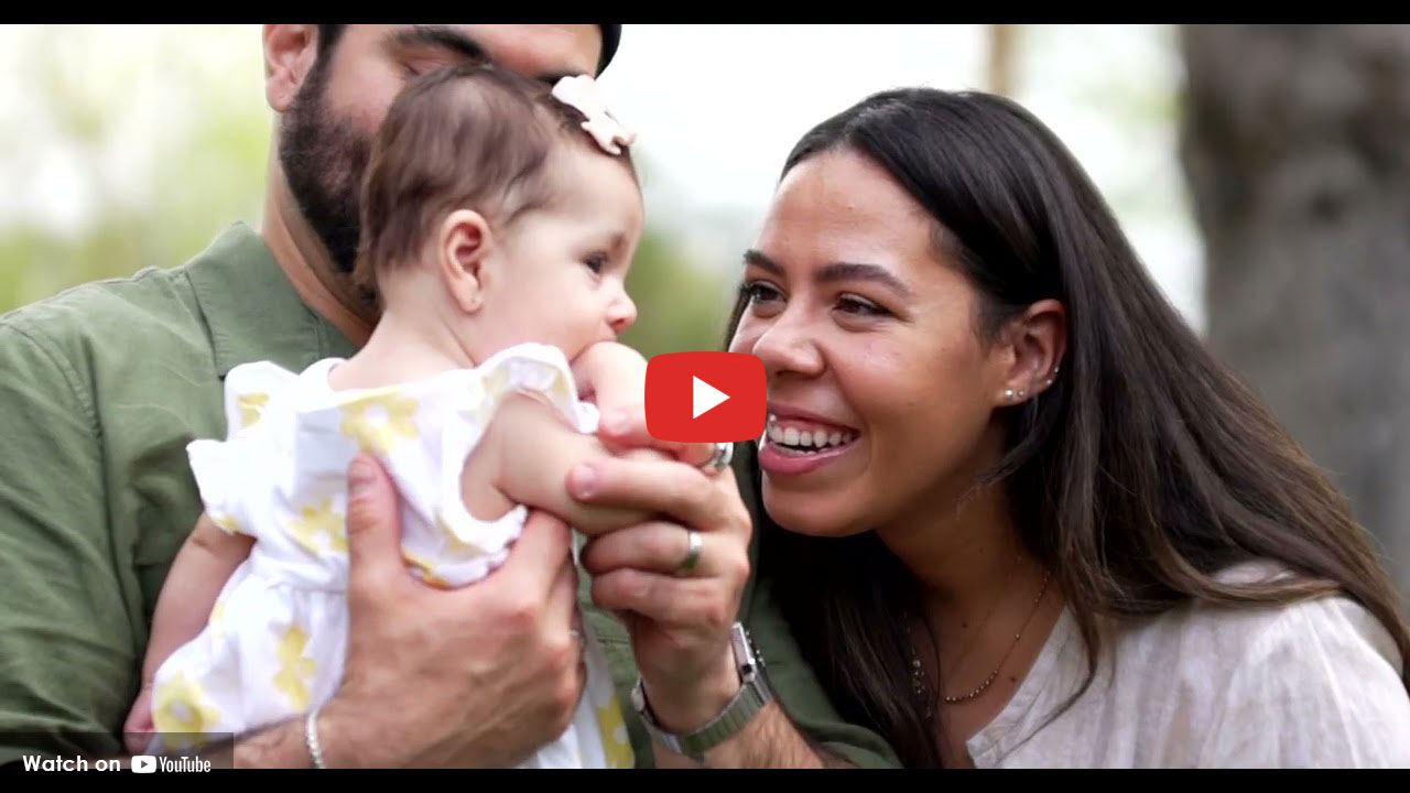 People smiling at their baby