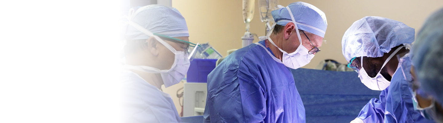 Colorectal surgeons in the operating room wearing PPE