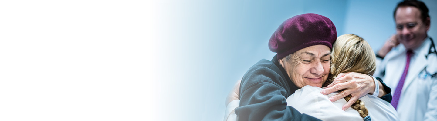 Patient embracing loved one during care journey