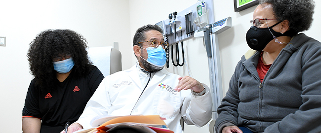 Doctor with patient discussing genetic diagnosing