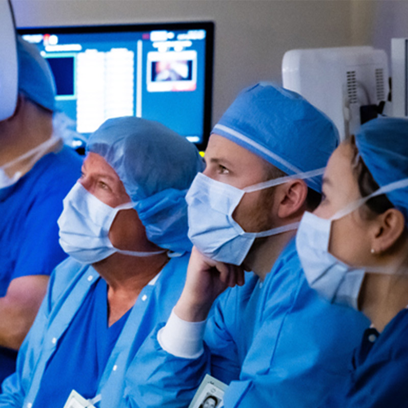 Surgeons wearing PPE in operating room