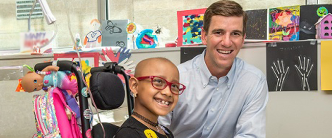 eli manning tackle kids cancer