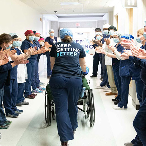Medical team member with patient in wheelchair