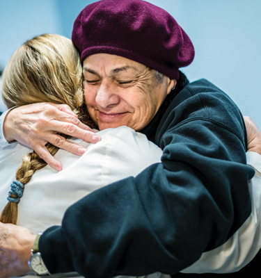 Patient hugging doctor