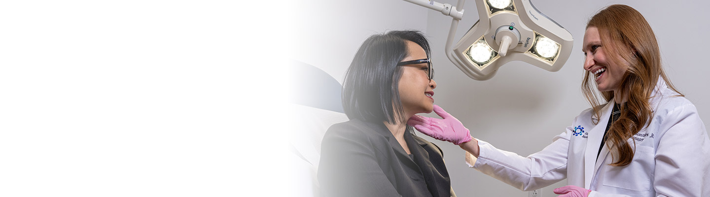 Dermatologist smiling at a patient at an office visit