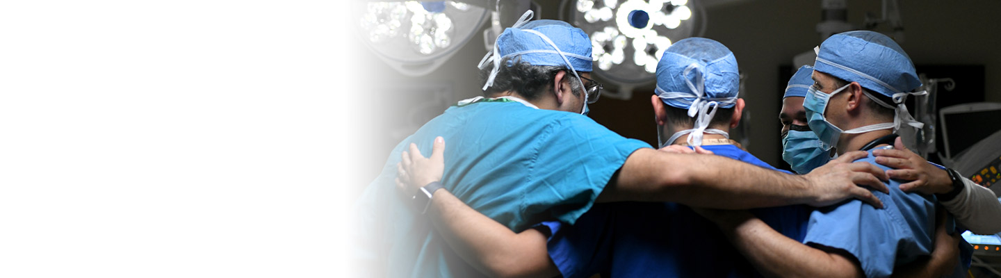 Surgeons Physicians huddling together with arms around each other's shoulders