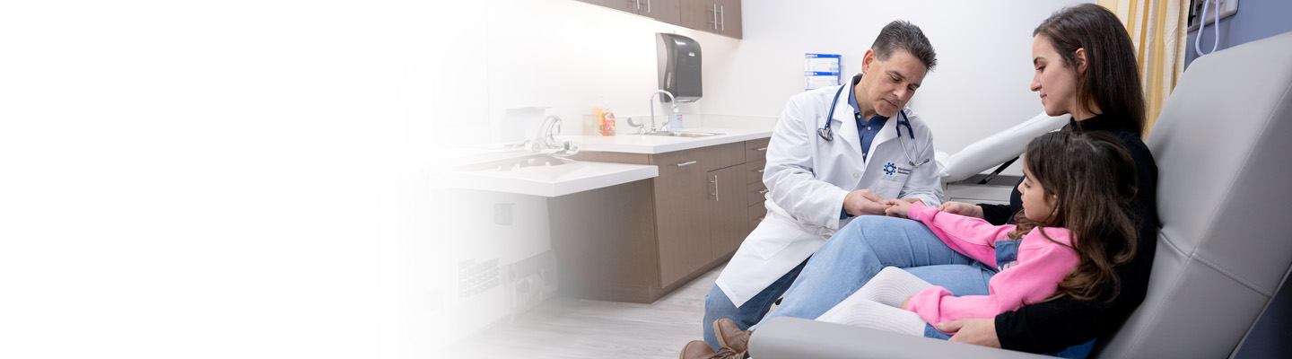 Doctor with pediatric patient and caregiver