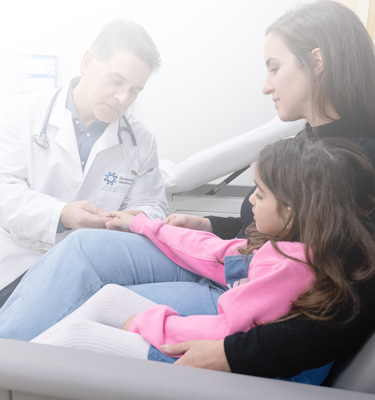 Doctor with pediatric patient and caregiver