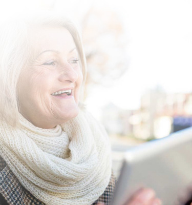 Senior citizens at park using iPad