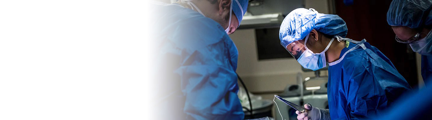 Surgeon holding forceps in the operating room