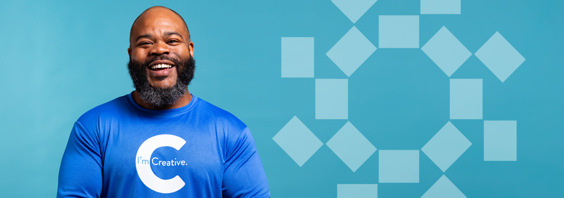 man smiling wearing creative shirt