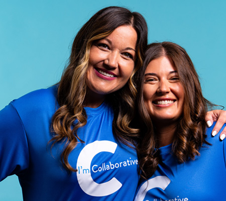 women smiling wearing collaborative shirts