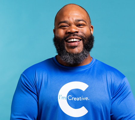 man smiling wearing creative shirt