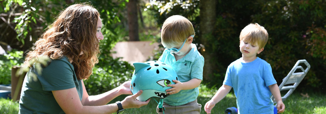 mom with two kids outside playing
