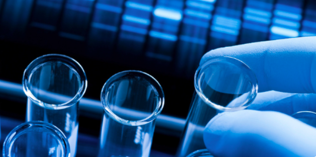 test tubes being handled with gloved hand
