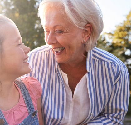 Young girl and her grandmother smiling