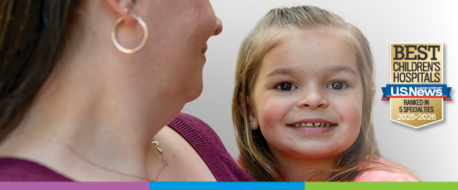 Mother holding her smiling child with US News and World Report badge on the right side of image