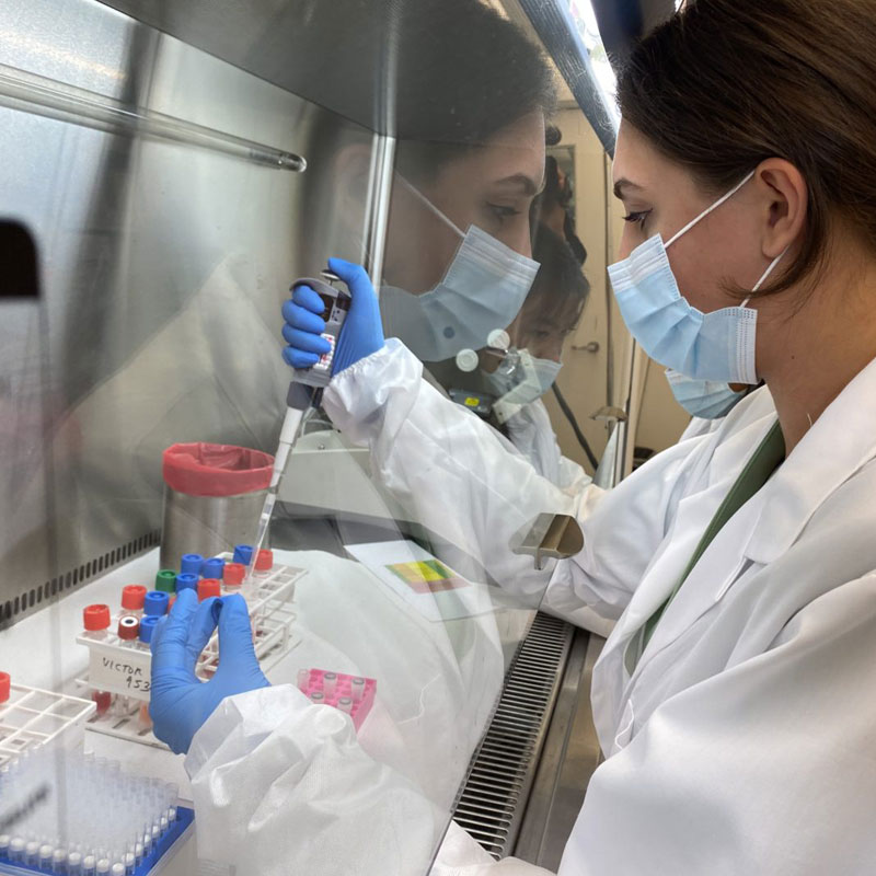 scientist with a syringe and viles