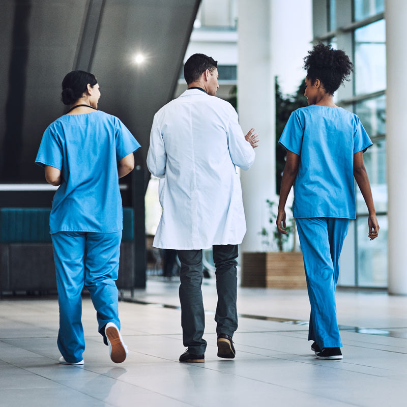 NJ hospital healthcare team walking in modern, bright medical facility