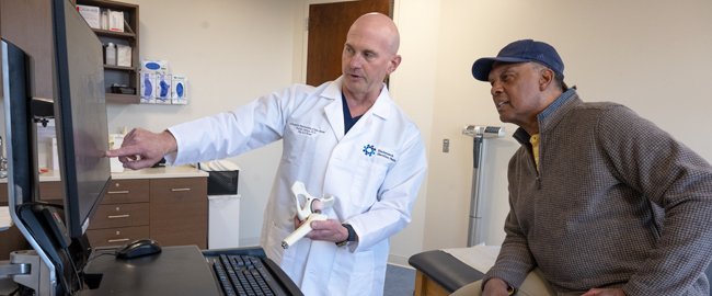 physician explaining x-ray results to patient