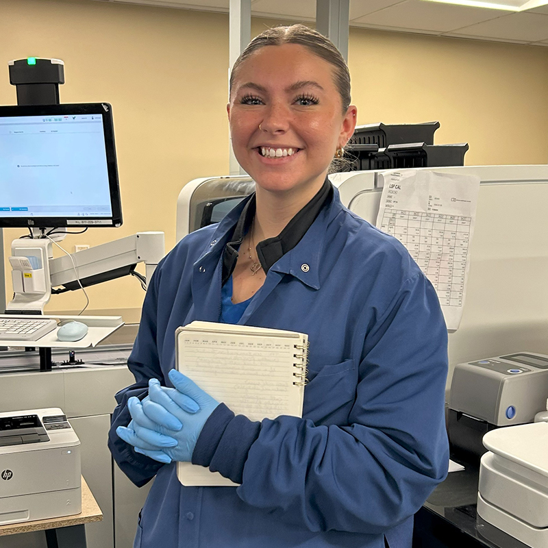 A smiling female student at the Florence M. Cook School of Medical Laboratory Science.