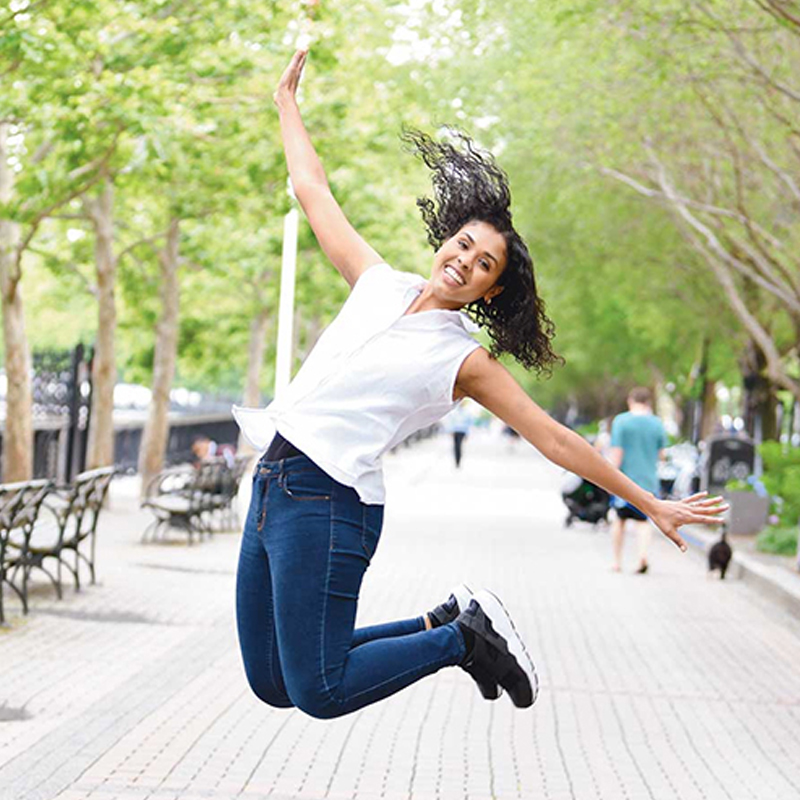 woman jumping and smiling with excitement