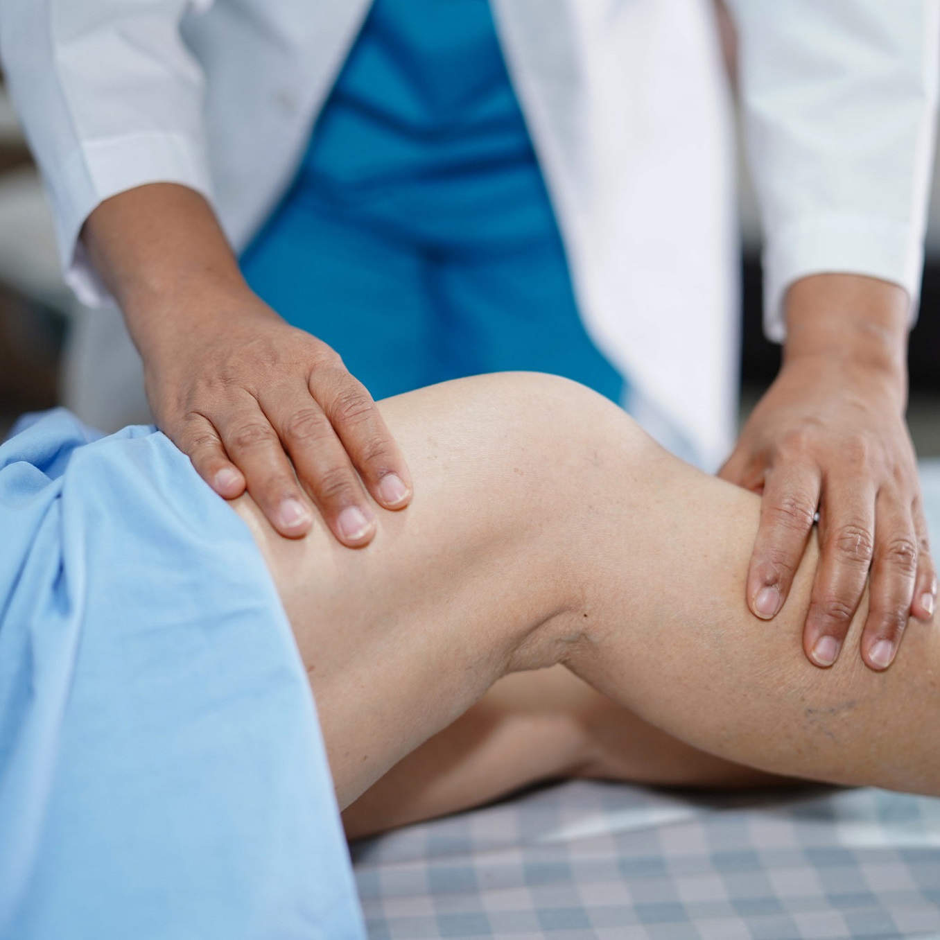 physician examining a patient's knee