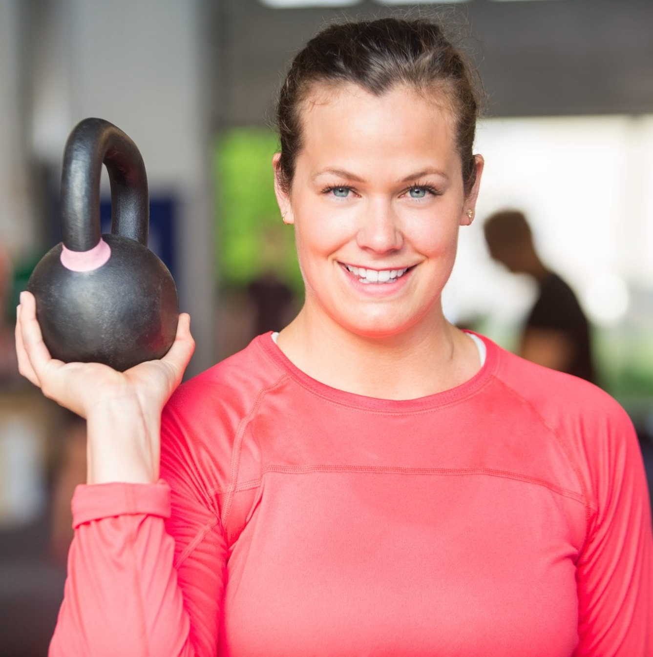 woman holding a kettle bell weight