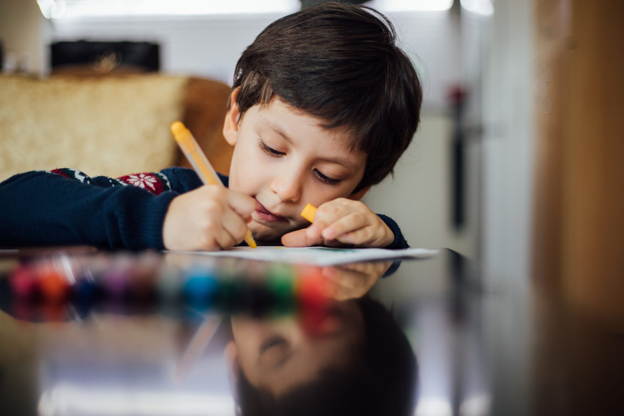 Child coloring at table
