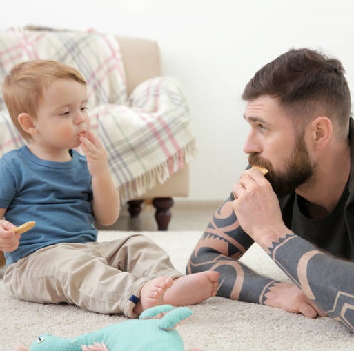 dad with son playing on the floor