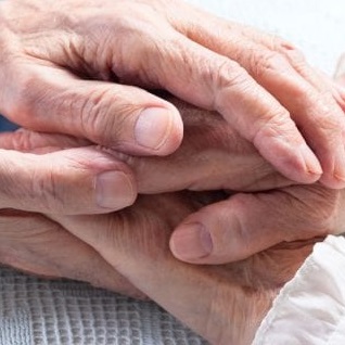 two peoples' hands on top of each other - comforting