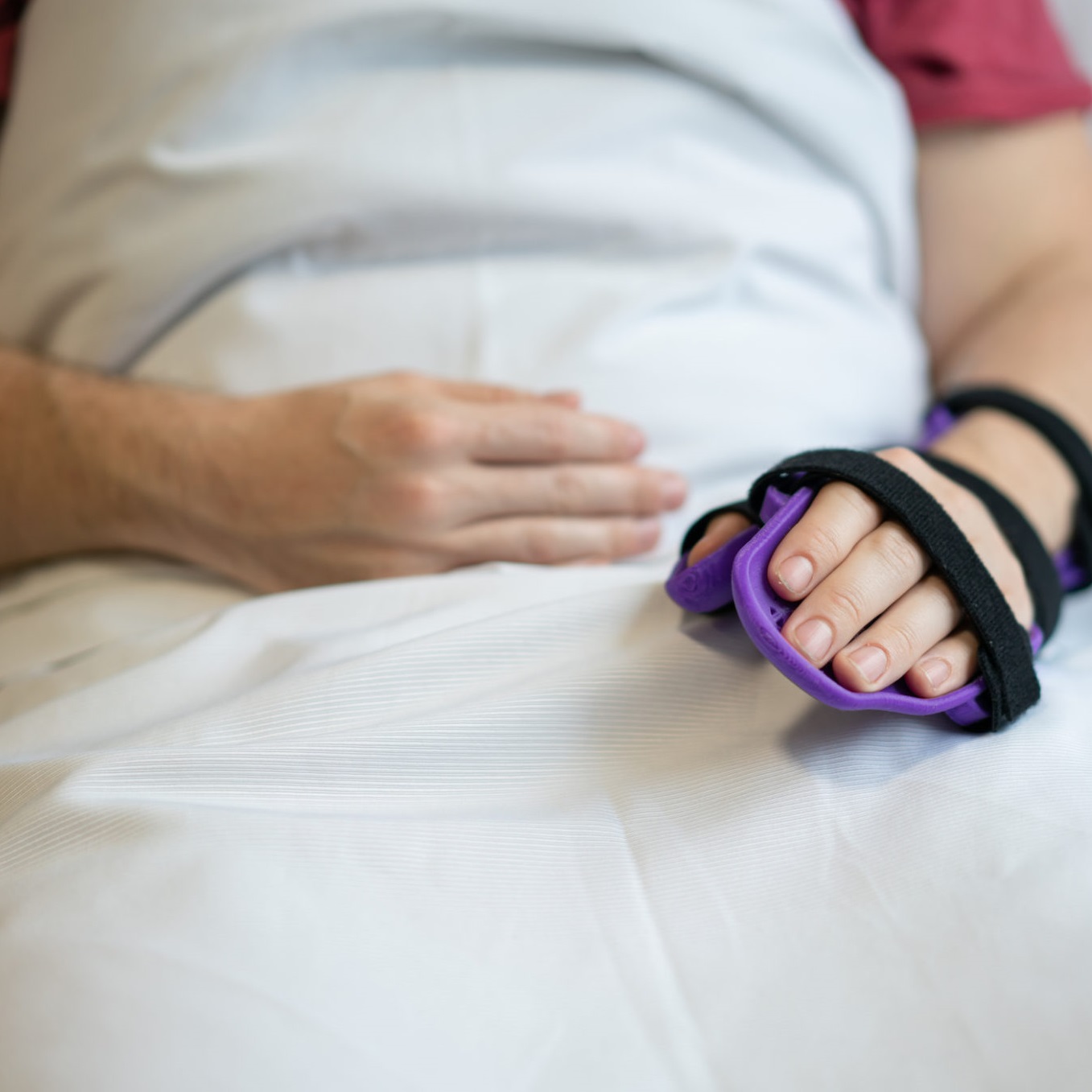 Person in bed with hand brace