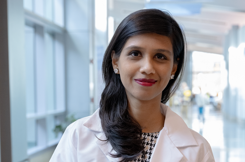 Dr. Farah Deshmukh smiling in the hallway of the hospital.