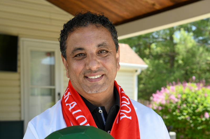 Hany M. Gendy, M.D., internal medicine specialist and international soccer fan, smiling and holding a soccer ball