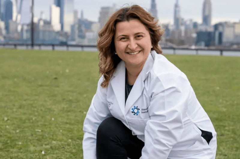 Family medicine specialist Anna Derian, M.D., crouches down to tie her shoe.
