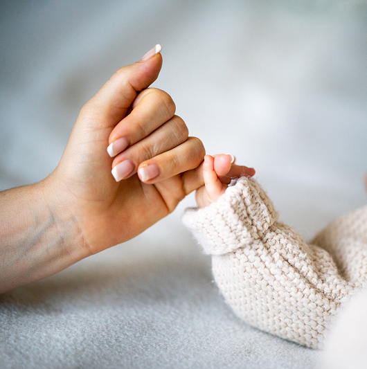 New mom holding baby's hand