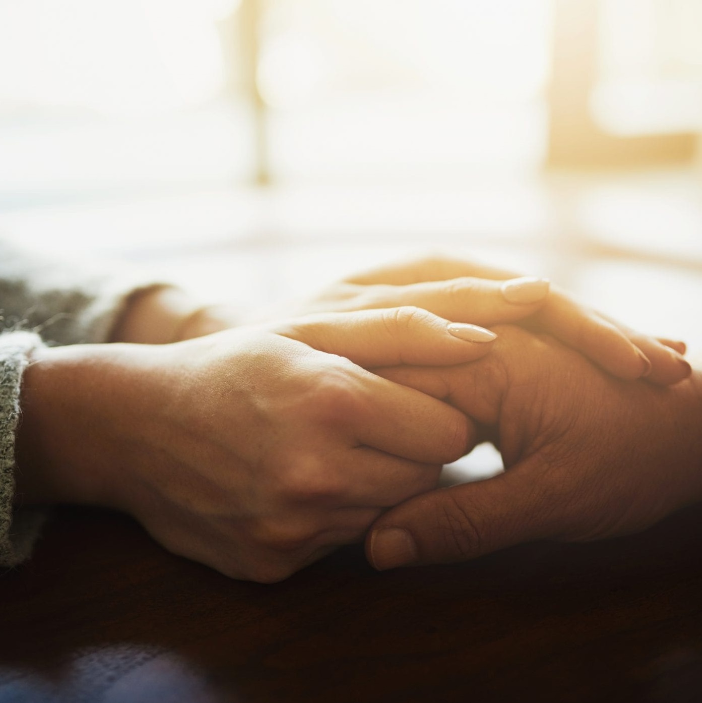 close up of two two people holding hands