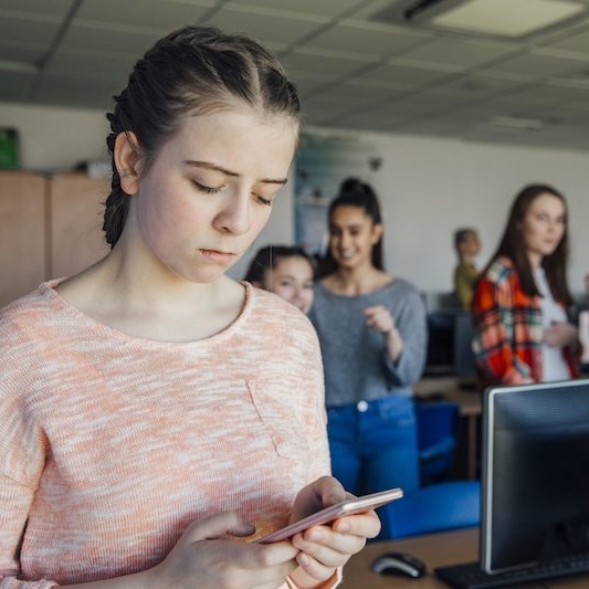 teen girl checking cell phone