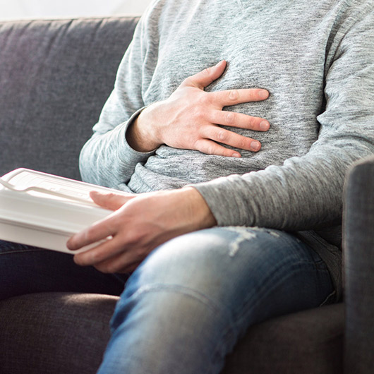 Person with hand over abdomen