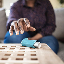 Man reaching for inhaler