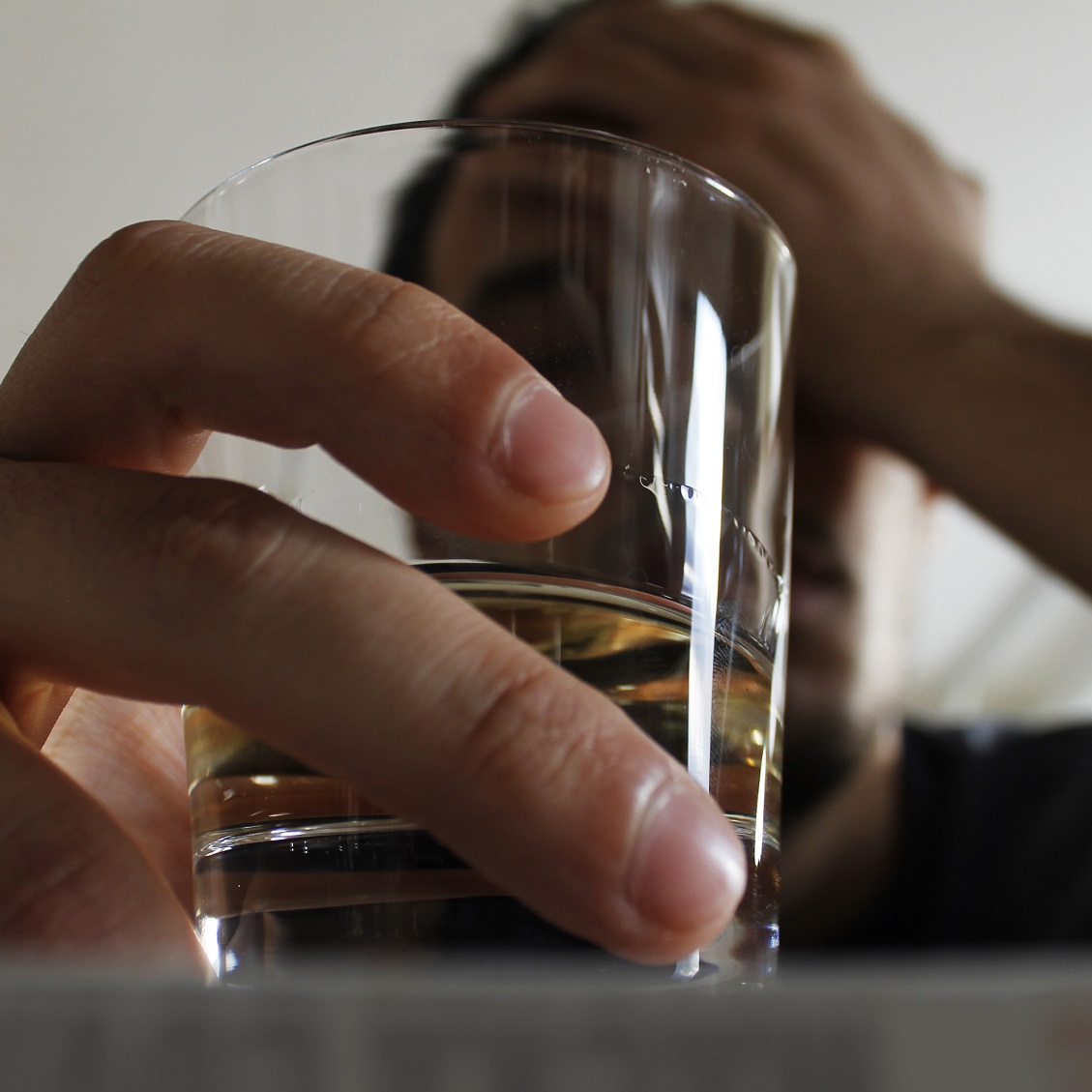 man holding shot glass
