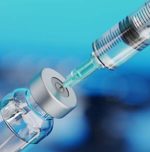 Close up of a syringe drawing a vaccine