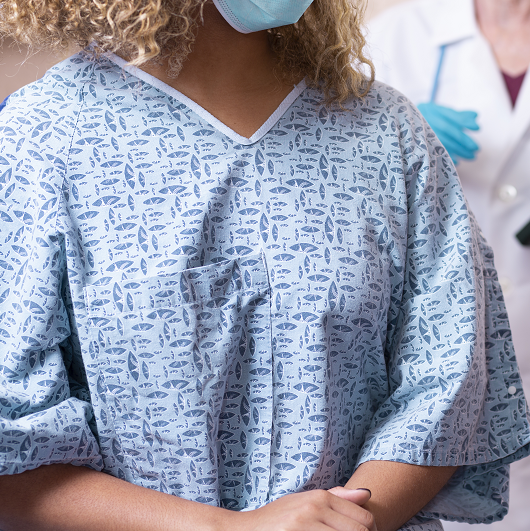 Young woman prepares for a breast exam, mammogram from her gynecologist doctor at hospital.