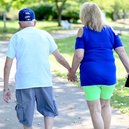 Elderly couple walking in the park. Walking decreases risk for dementia