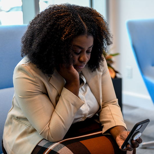 Woman on her cell phone looking depressed and stressed out.