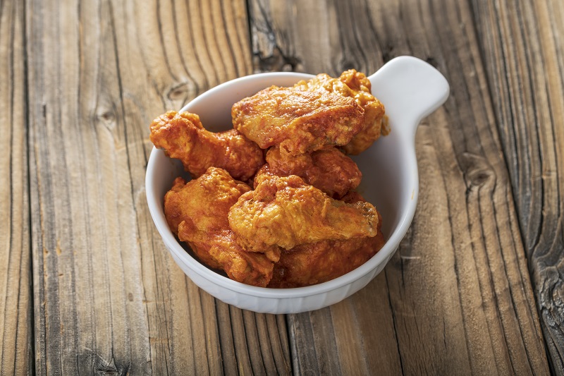 buffalo air fried chicken in a bowl on a table