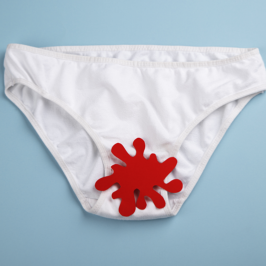 White underwear with a splatter of red, representing vaginal bleeding. Unexpected bleeding after sex.