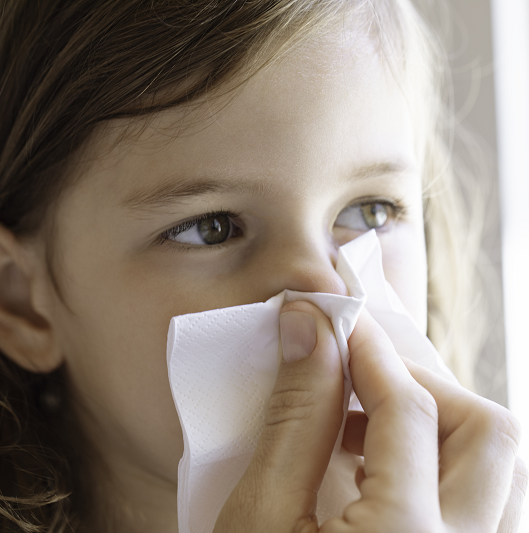 Close up shot of a mother holding a child's nose to stop a nosebleed.