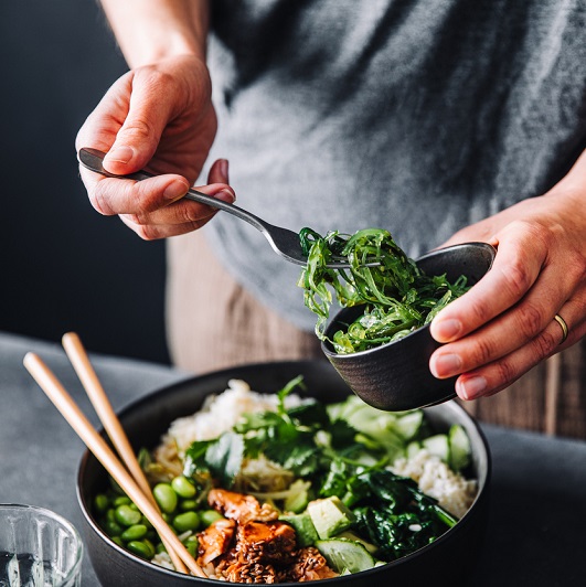 Close up shot of a person preparing a healthy salad.